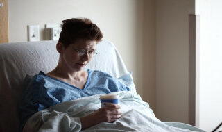 Woman in hospital bed.