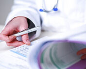 Physician holding a pen and medical chart