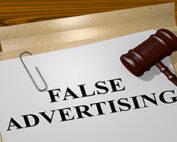 Court documents with a paper that reads "FALSE ADVERTISING"