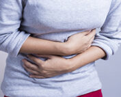 Woman holding her abdomen in pain