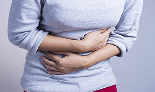 Woman holding her abdomen in pain