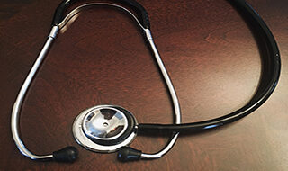stethoscope on a wooden tabletop
