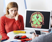 neurological injuries - woman looking at ct scan with doctor
