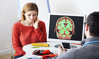 neurological injuries - woman looking at ct scan with doctor
