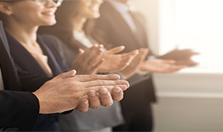a group of people clapping their hands