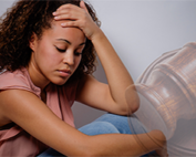 a woman stressed out with her hand on her head. a gavel in the background