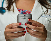 female doctor holding cell phone