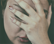 woman with hand on face - transvaginal mesh pain